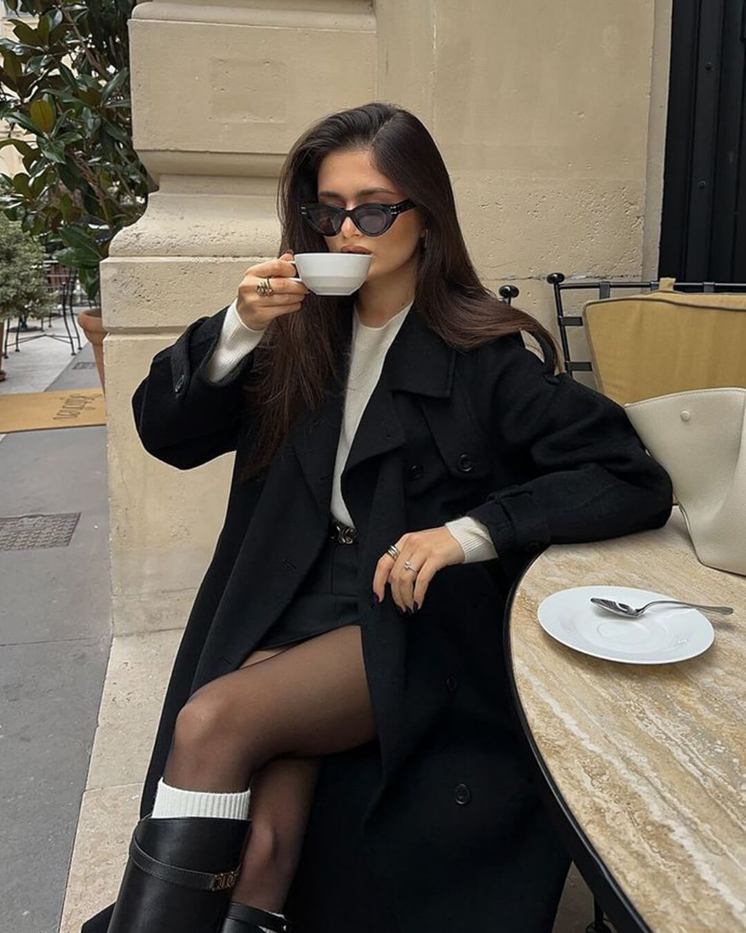 Women's Long Double-Breasted Trench Coat in Black - alternate angle showing fit and fabric detail